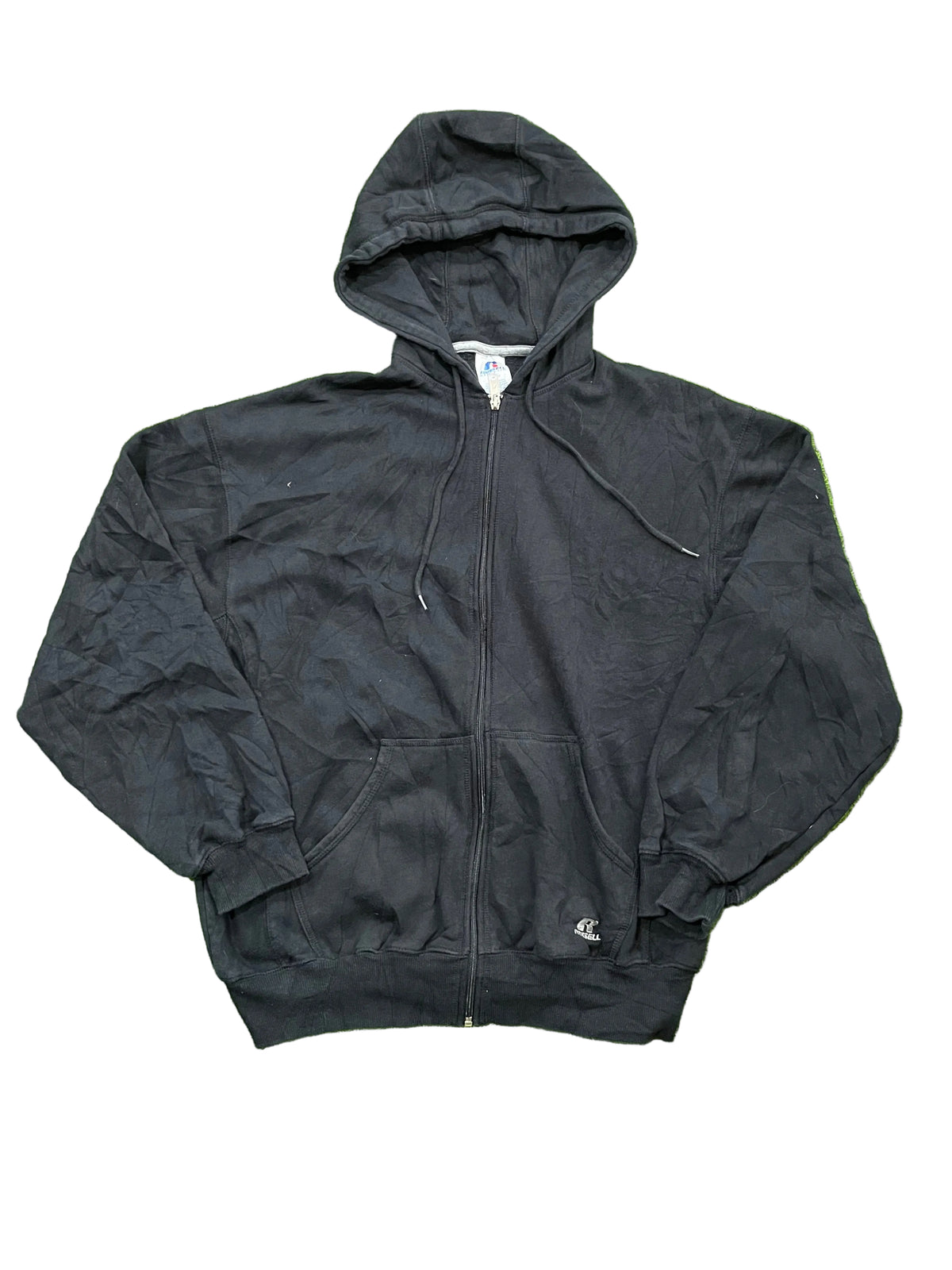 A black zip-up with bare feet visible at the bottom edge of the frame.