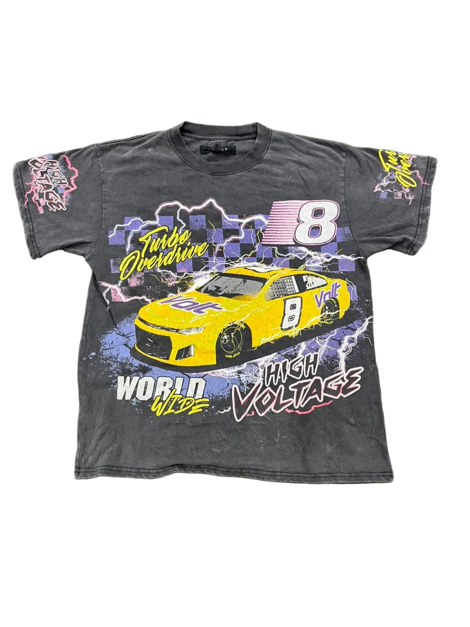 A faded black graphic t-shirt featuring a yellow race car and the number 8, laid flat on a green shag rug. The shirt includes 'Turbo Overdrive' and 'High Voltage' text.