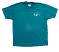 A teal short-sleeve t-shirt. The shirt features a small white graphic on the left chest depicting a lighthouse and mountains with the text 'HICOTIA PARK'.