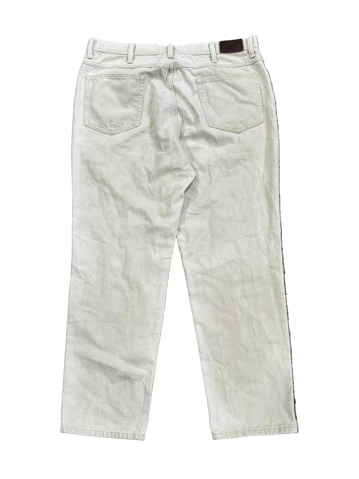 A pair off-white or cream-colored denim jeans showing the back pockets and waistband.