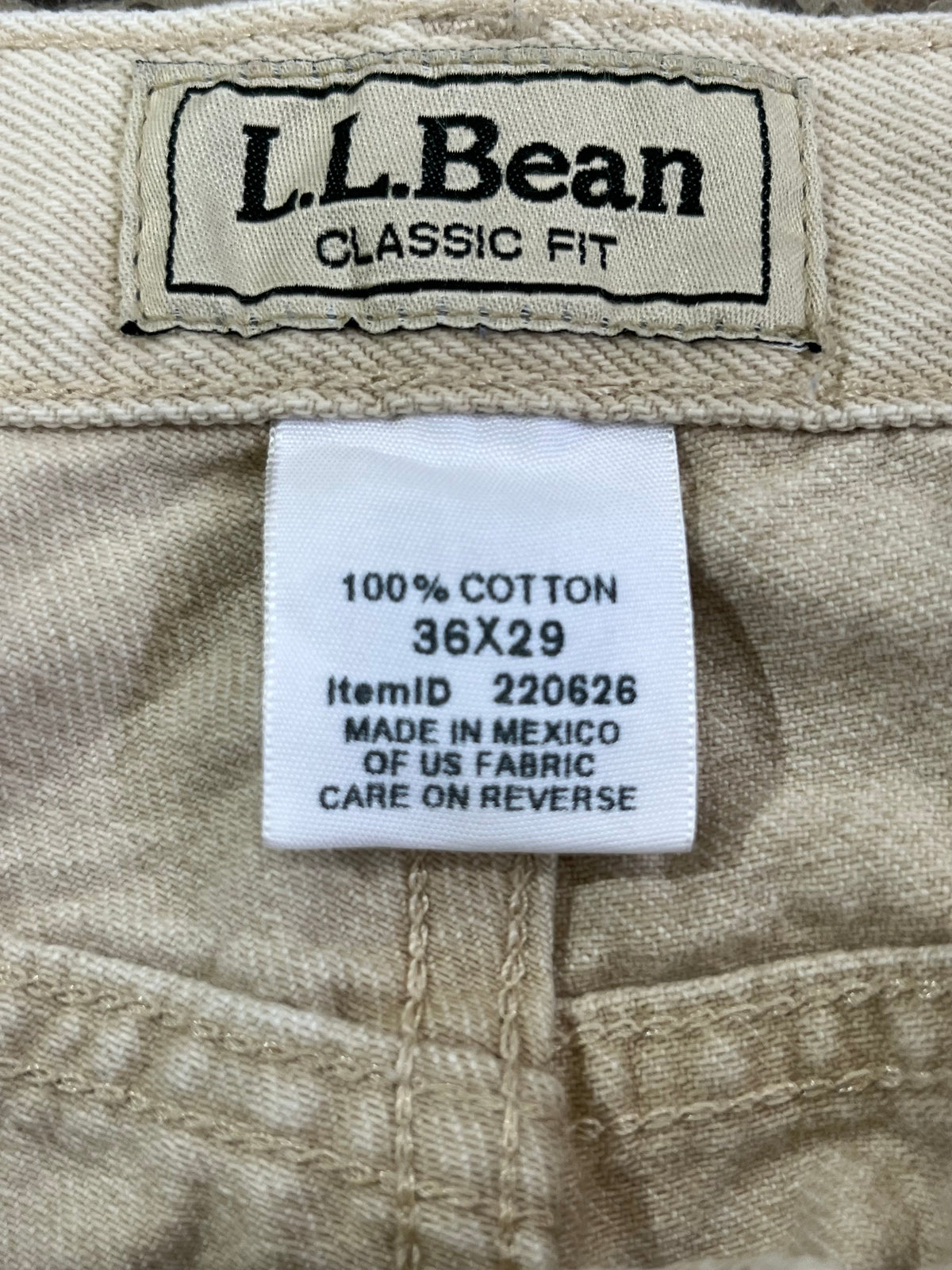 Close-up of the inside waistband of tan denim jeans showing the L.L.