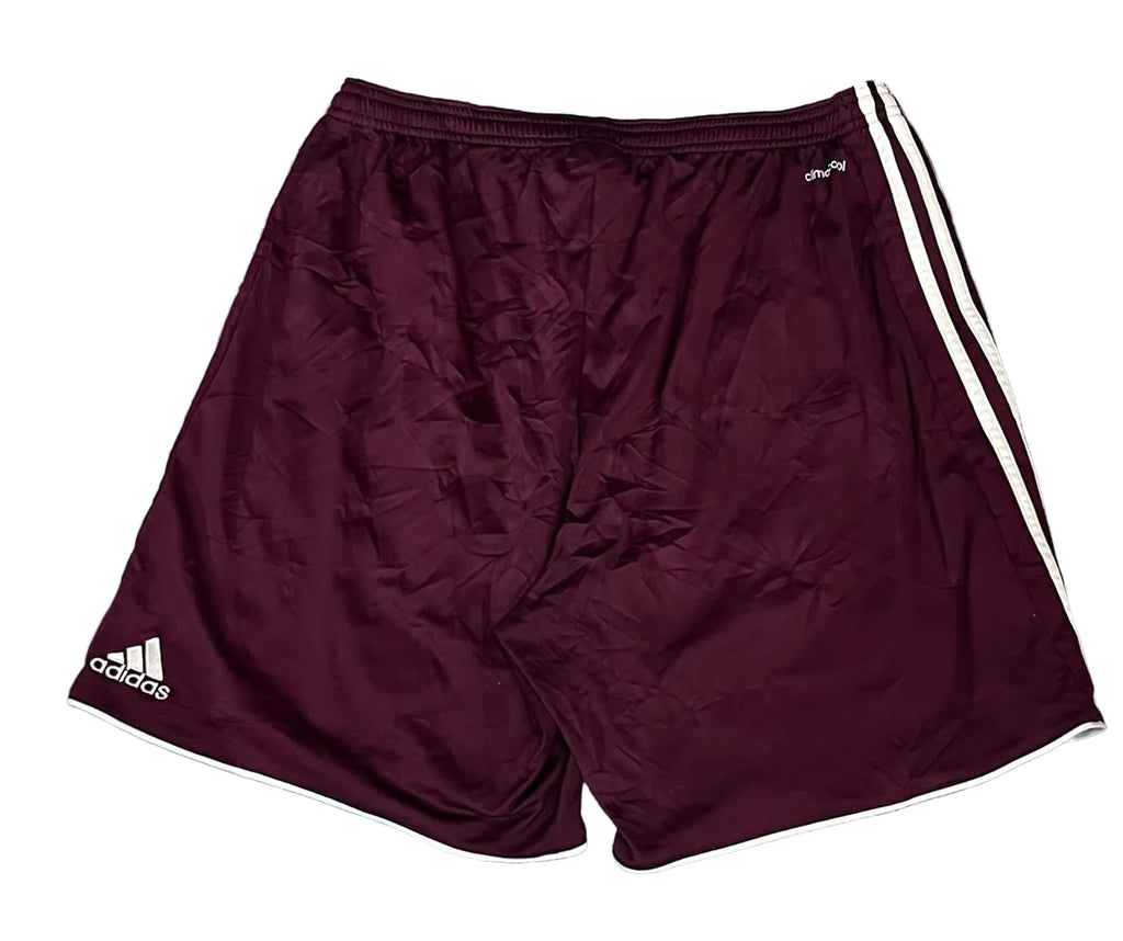 A pair of Adidas athletic shorts in maroon with white stripes and logos, 