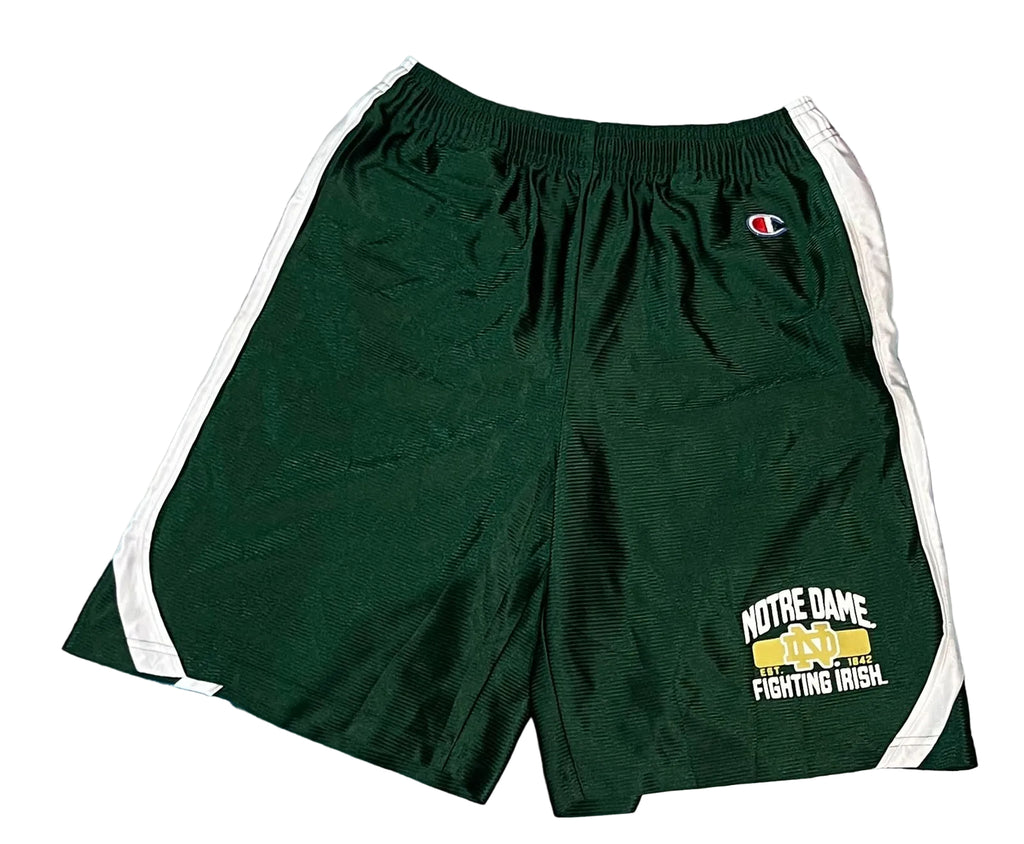 Dark green Champion mesh athletic shorts with white side stripes and a Notre Dame Fighting Irish logo on the left leg