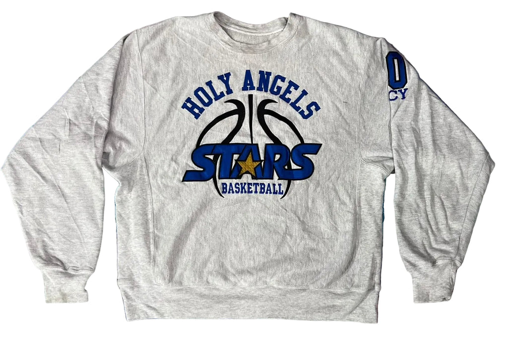 A light heather gray crewneck sweatshirt featuring a 'Holy Angels Stars Basketball' graphic on the front