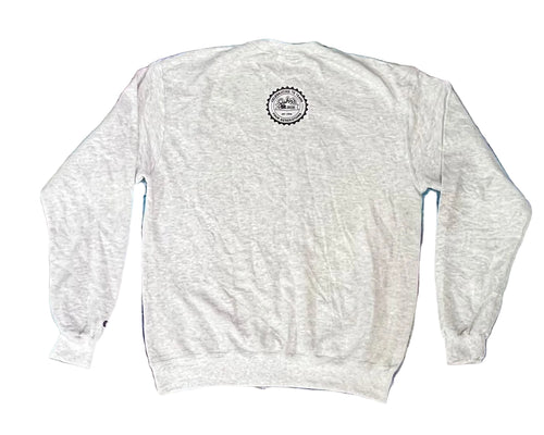 A light heather gray crewneck sweatshirt shown from the back, featuring a circular black and white graphic printed on the upper back