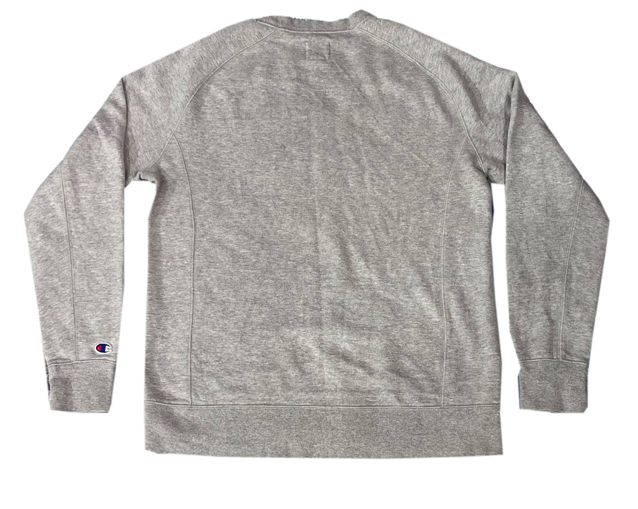 A heather gray long-sleeve crewneck sweatshirt shown from the back, featuring a small Champion logo patch on the left sleeve cuff.
