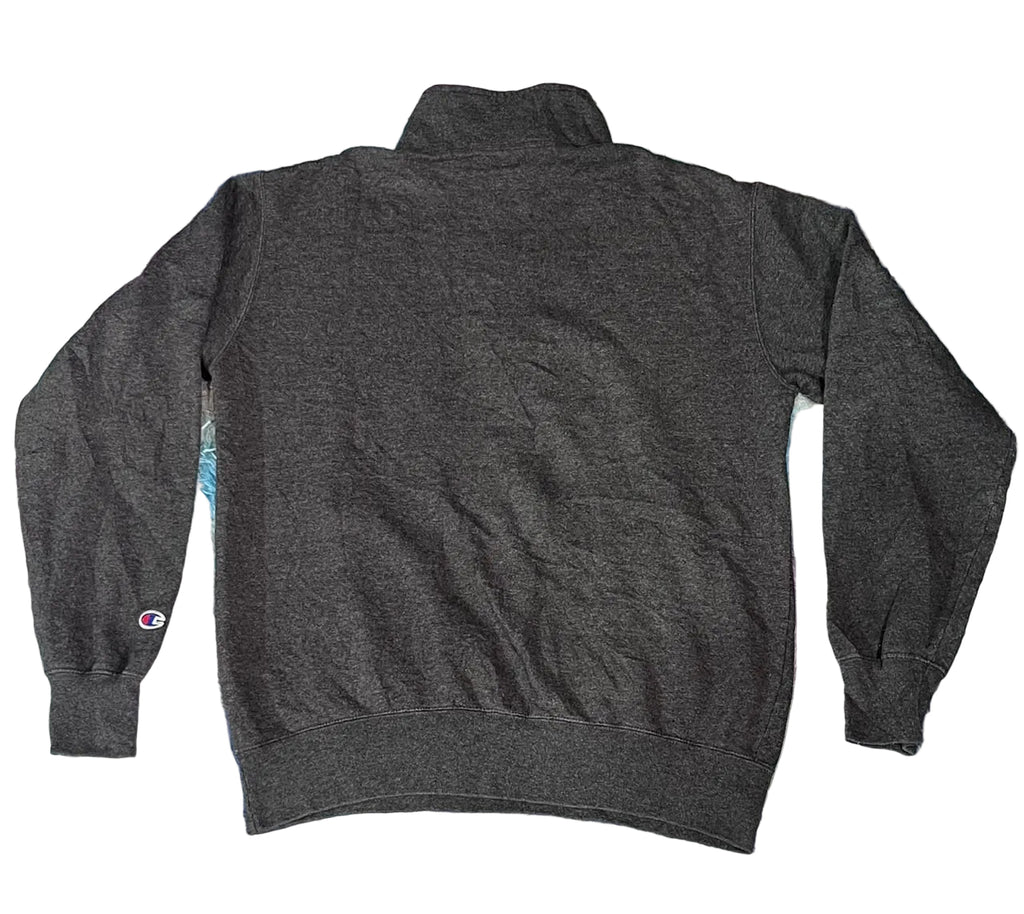 A dark gray heathered quarter-zip sweatshirt with a mock neck A small Champion logo is visible on the left sleeve cuff.