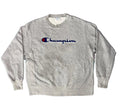 A heather gray crewneck sweatshirt with the embroidered Champion logo on the chest