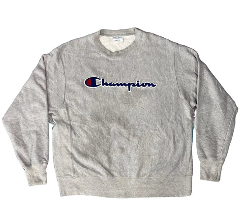 A heather gray crewneck sweatshirt with the embroidered Champion logo on the chest