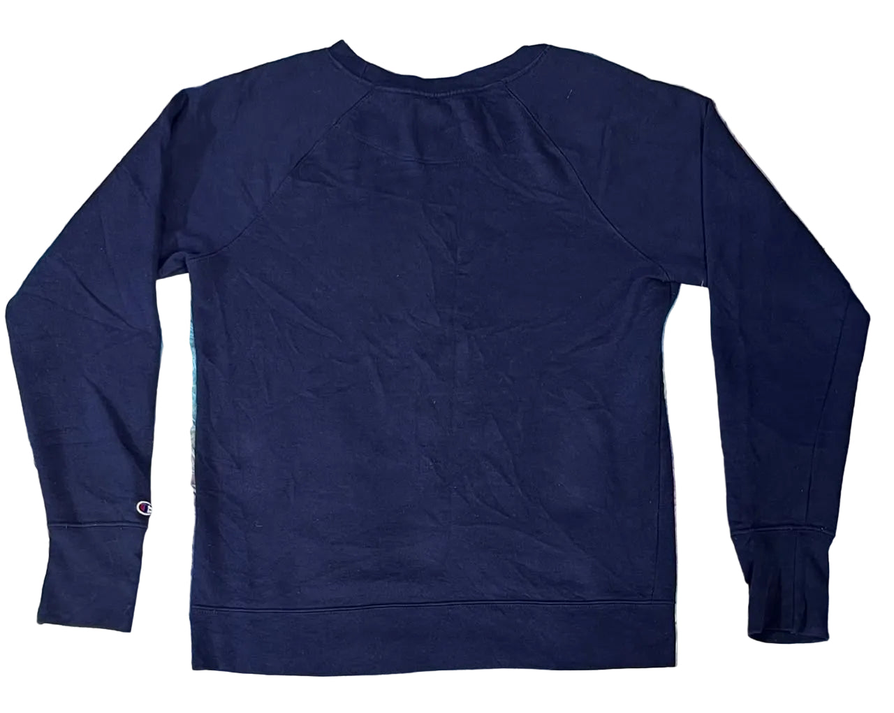 A dark navy blue long-sleeve crewneck sweatshirt laid flat on a colorful, textured faux fur surface.