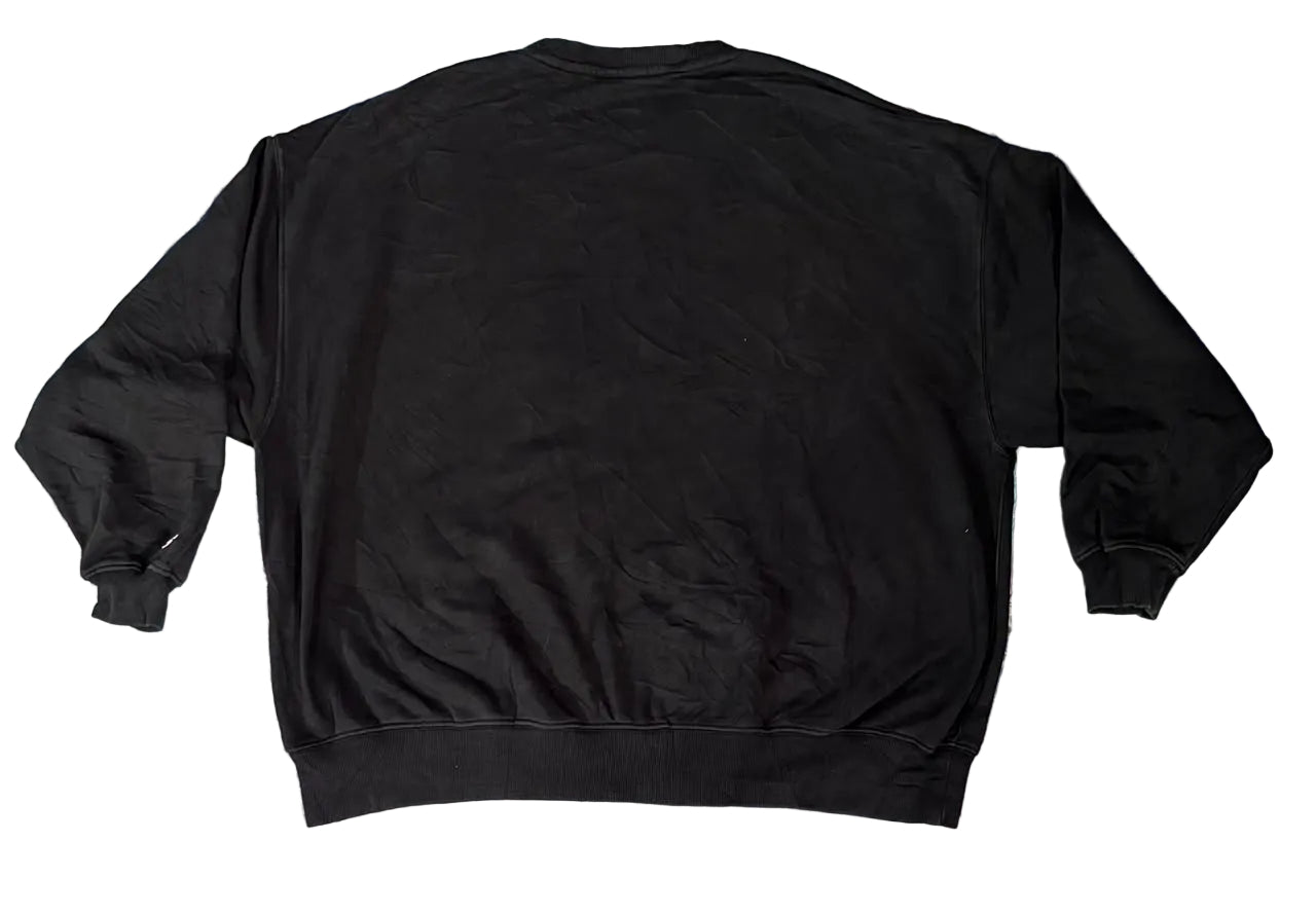 A black crewneck sweatshirt on  a white plain backghround 