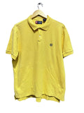 Chaps yellow polo shirt on a hanger against a white wall