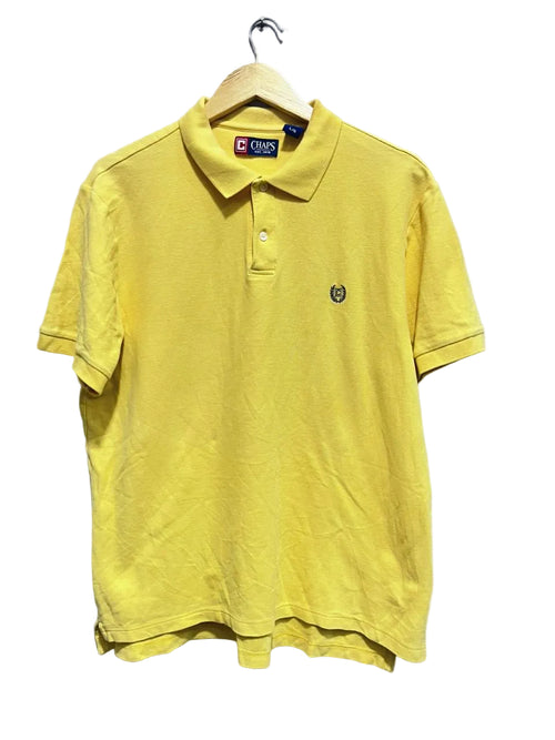 Chaps yellow polo shirt on a hanger against a white wall