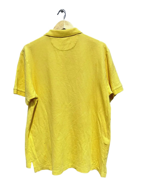 Chaps yellow polo shirt on a hanger against a white wall
