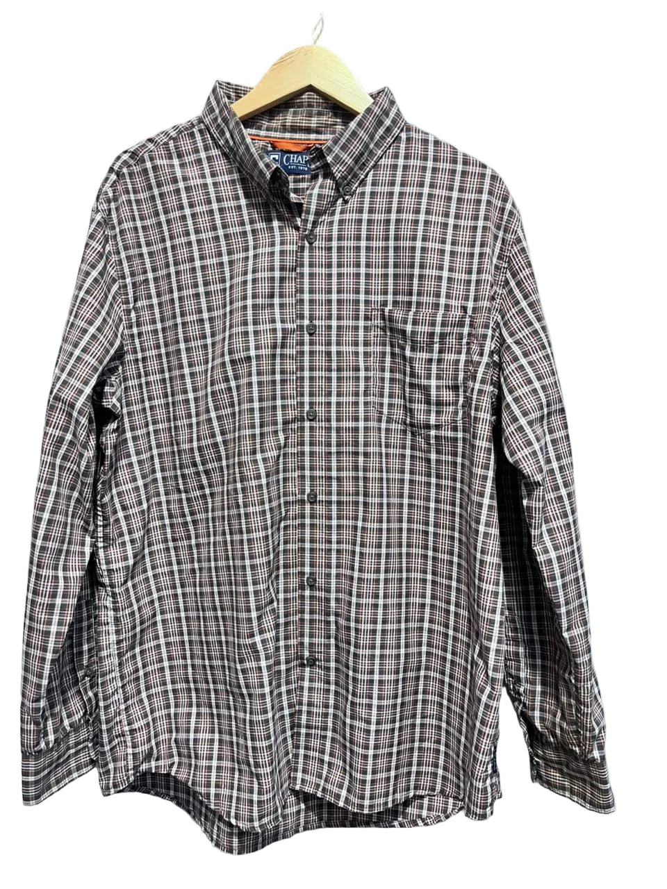 Chaps Men shirt on a hanger against a white wall