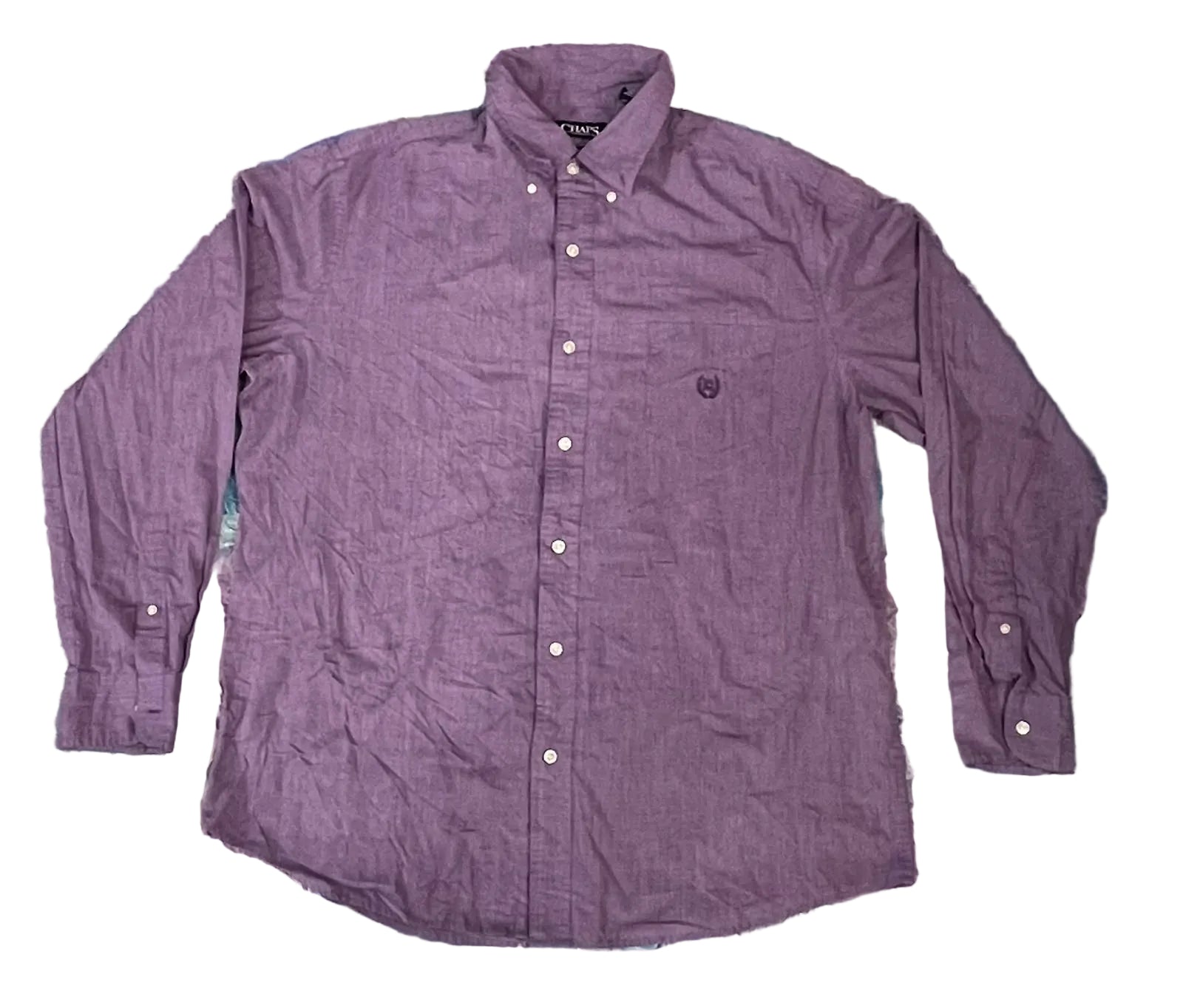 A purple long-sleeve button-down shirt. The shirt features a small embroidered shield logo on the left chest, which is the signature logo of the brand Pique.