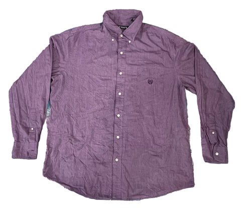 A purple long-sleeve button-down shirt. The shirt features a small embroidered shield logo on the left chest, which is the signature logo of the brand Pique.
