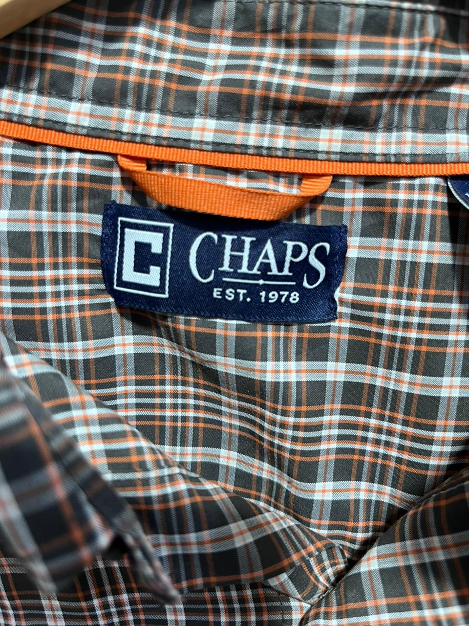 Close-up of a plaid shirt with a Chaps label 