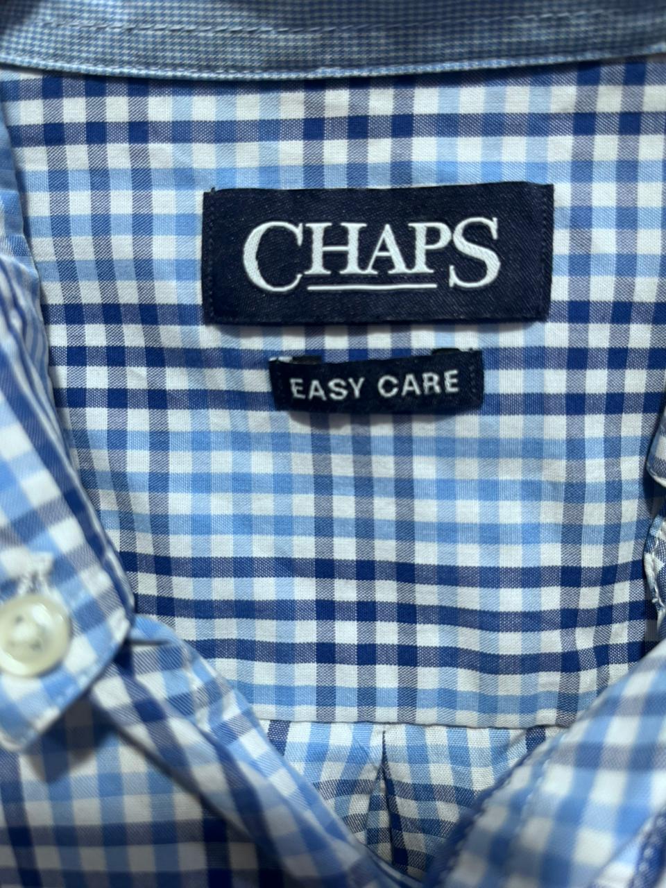 Close-up of a blue and white checkered shirt with a Chaps label.