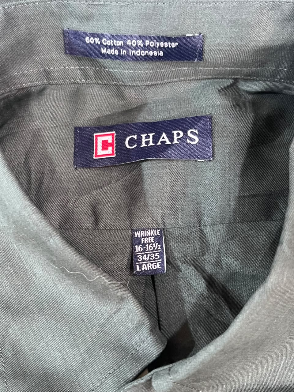 Close-up of the inside collar of a gray CHAPS shirt, showing the brand label, size tag, and fabric composition.