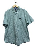 chaps green checkered shirt on a hanger against a gray wall