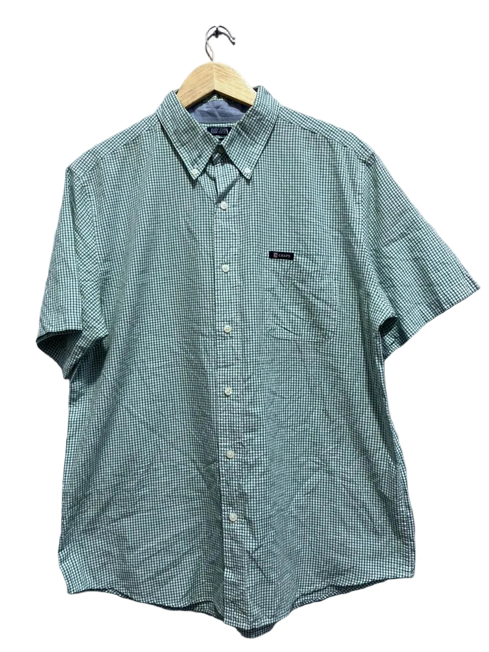 chaps green checkered shirt on a hanger against a gray wall