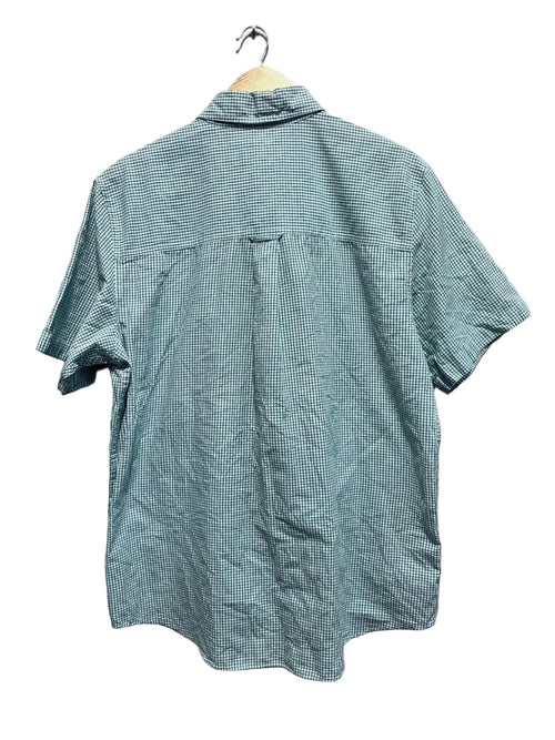 CHAPS Green checkered shirt on a hanger against a gray wall.