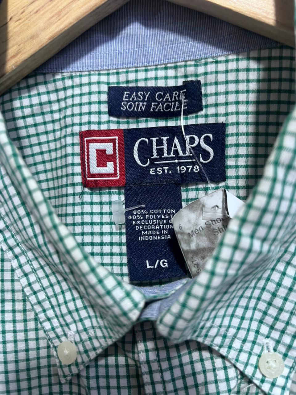 Close-up of a green and white checkered shirt with a Chaps label.