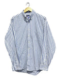 Chaps men blue and white striped shirt on a hanger against a white wall.