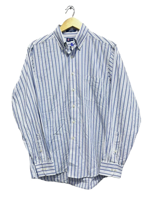 Chaps men blue and white striped shirt on a hanger against a white wall.