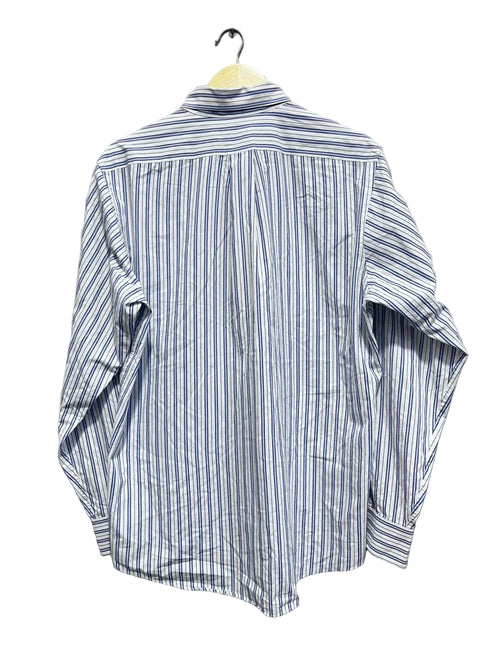 Chaps men shirt blue and white striped shirt on a hanger against a white wall.