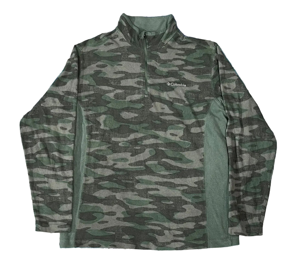 A long-sleeve quarter-zip pullover jacket with a green and gray camouflage pattern,. The Columbia brand logo is visible on the left chest.