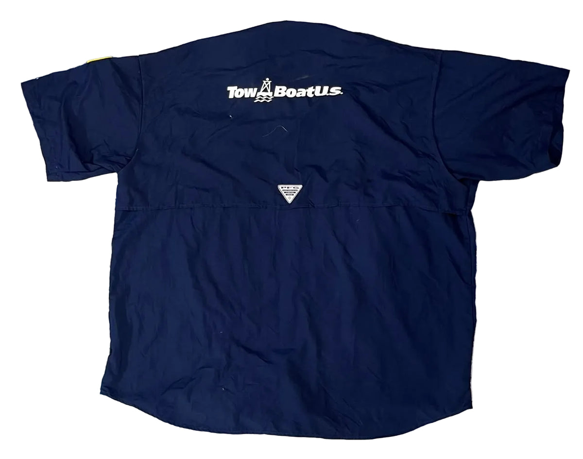 A navy blue short-sleeve Towa Boat US windbreaker jacket The back of the jacket features the white Towa Boat US logo printed across the upper back and a small triangular logo near the lower back.