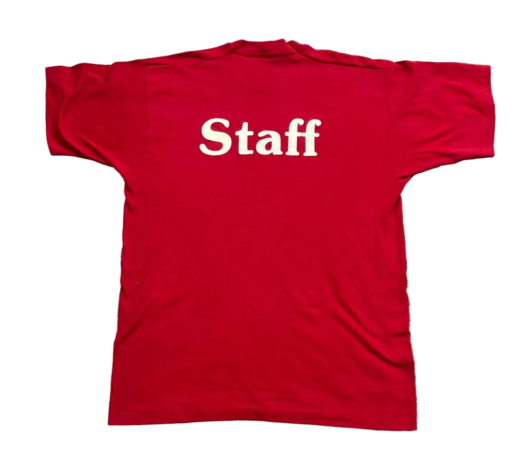 A red short-sleeve t-shirt with the word 'Staff' printed in white serif text across the chest, 