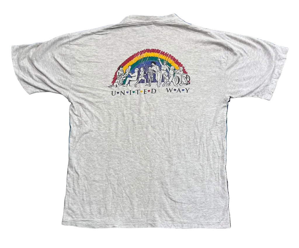 A light gray heather short-sleeve t-shirt The back of the shirt features a colorful graphic of a rainbow with figures and the text 'UNUNITED WOARY'.