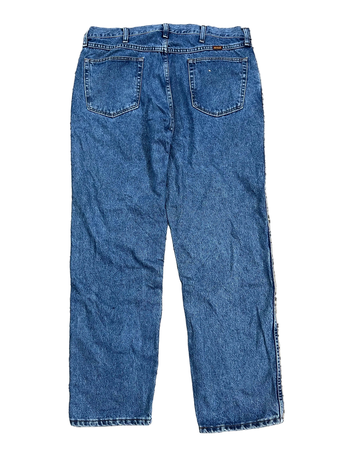 A pair of blue denim jeans showing the back pockets and waistband.
