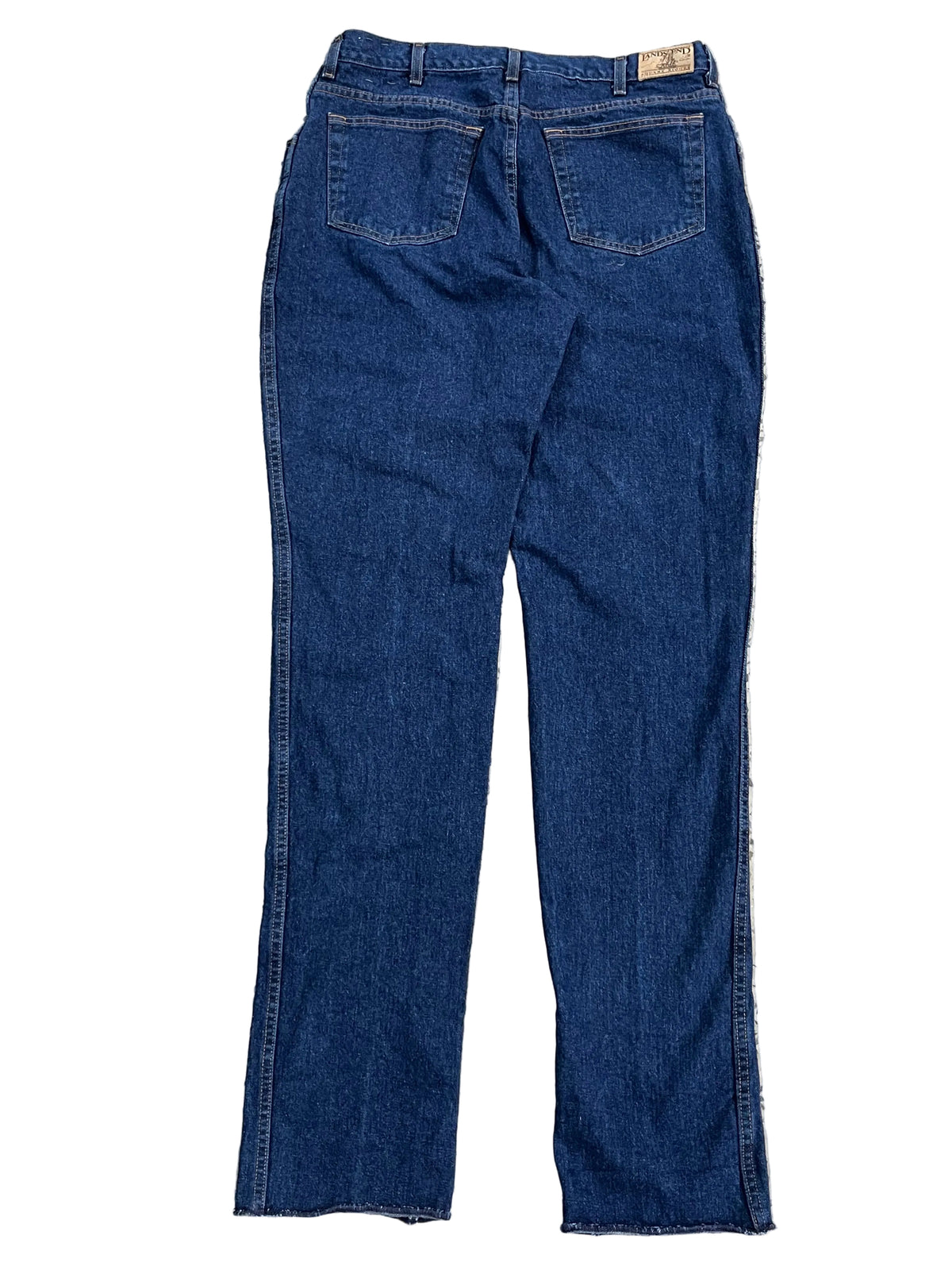 A pair of dark blue denim jeans shown from the back, ON THE WHITE BACKGROUND