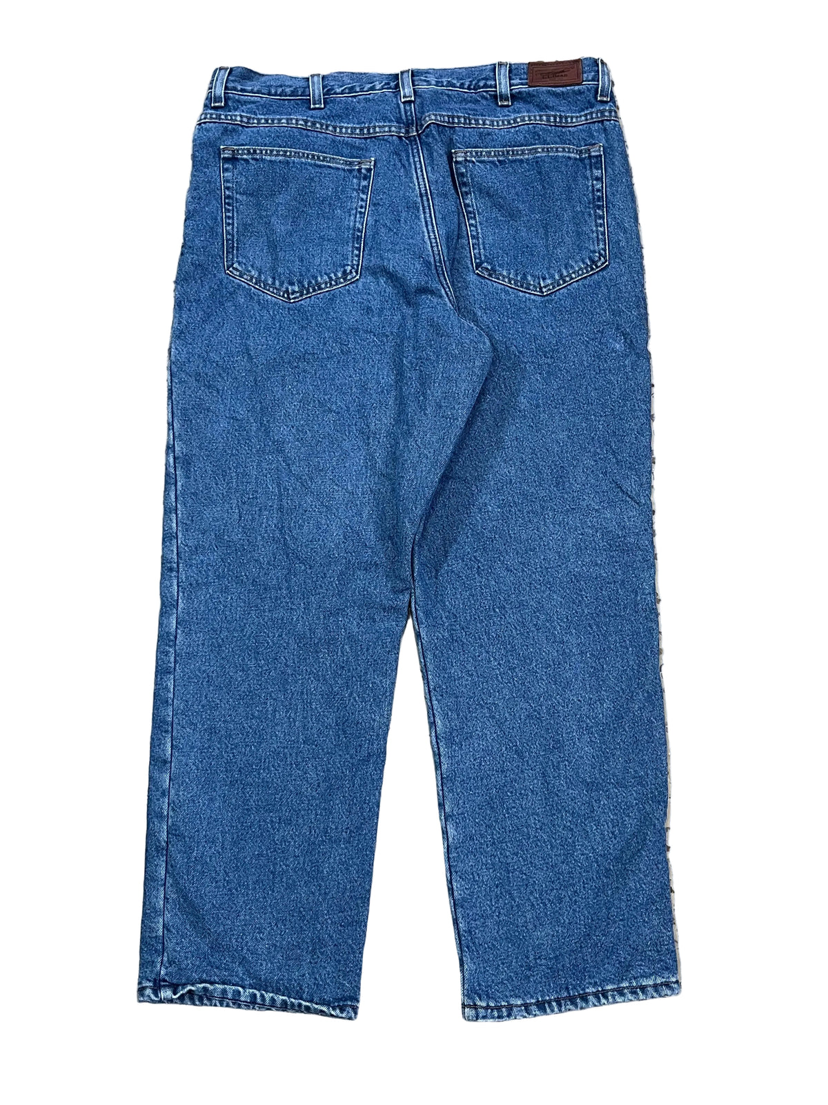 A pair of blue denim jeans shown from the back,