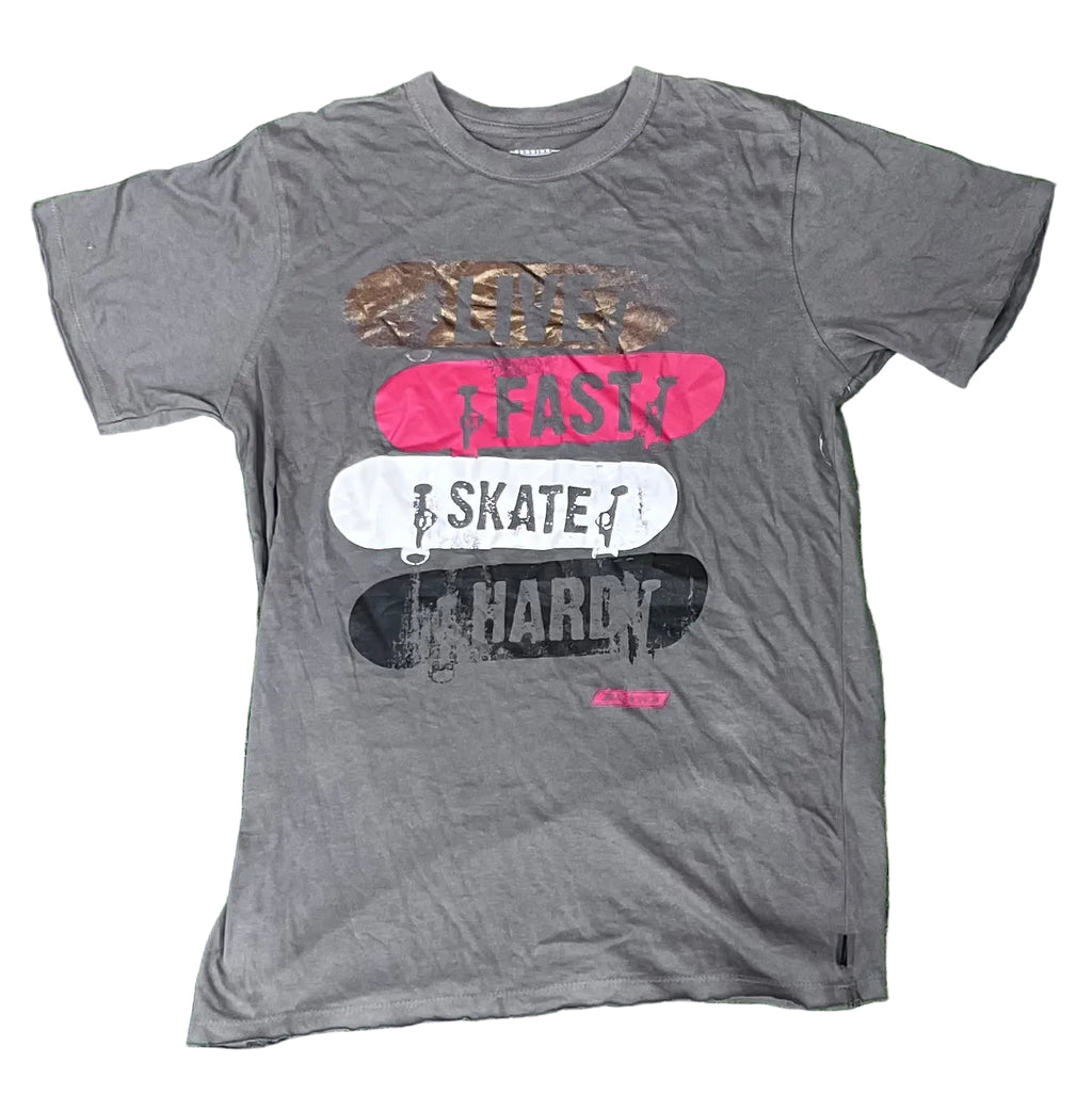 A dark gray graphic t-shirt featuring stacked skateboards in brown, pink, white, and black with the words 'SKATE FAST HARD' printed on them