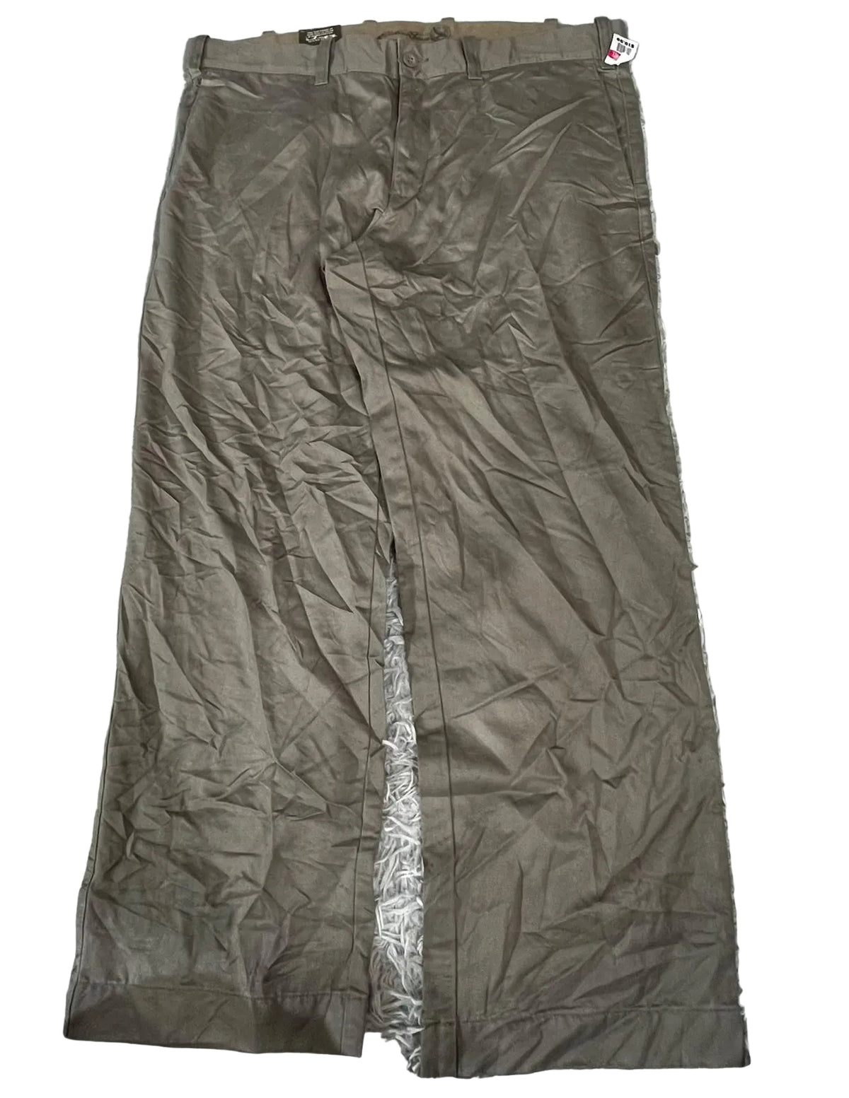 A pair of brown wide-leg trousers showing a wrinkled texture and a small red and white brand tag near the waistband.