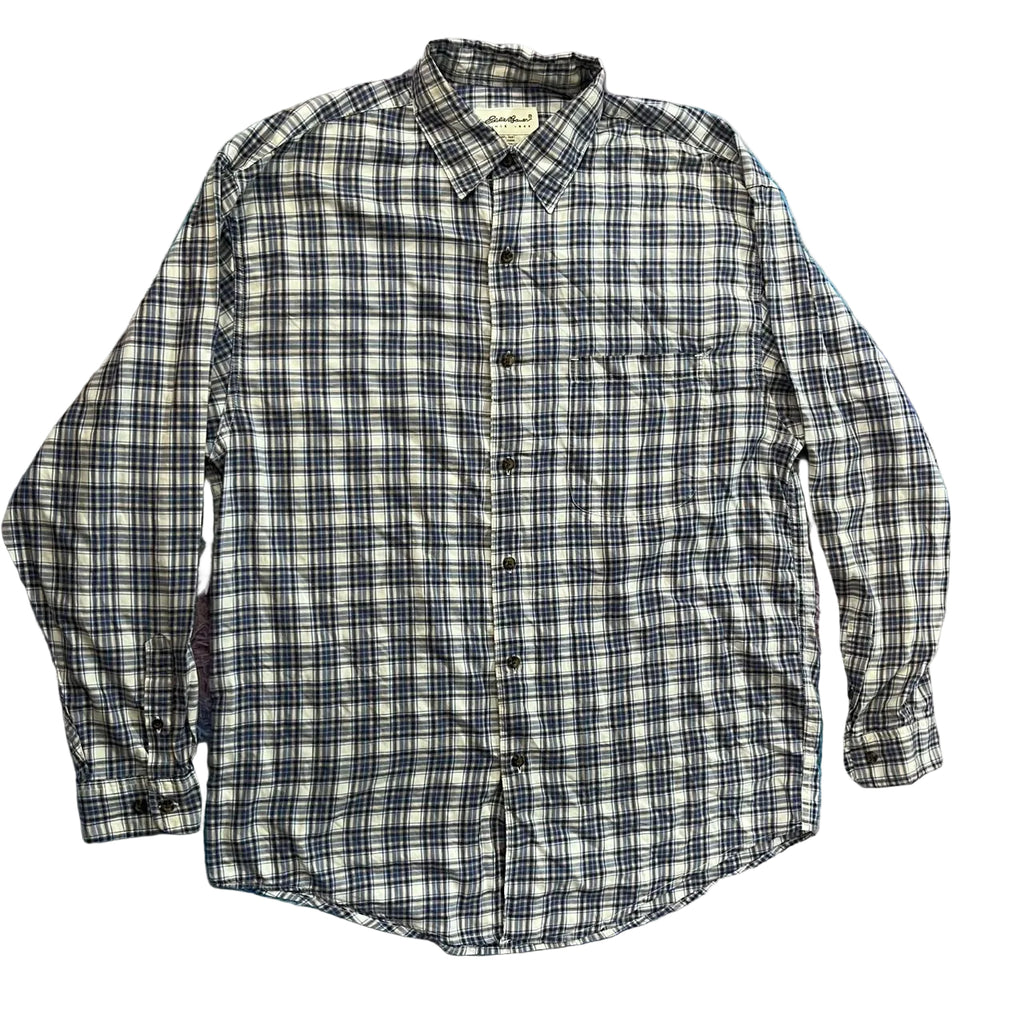 A long-sleeve button-up plaid shirt in black, white, and gray, 
