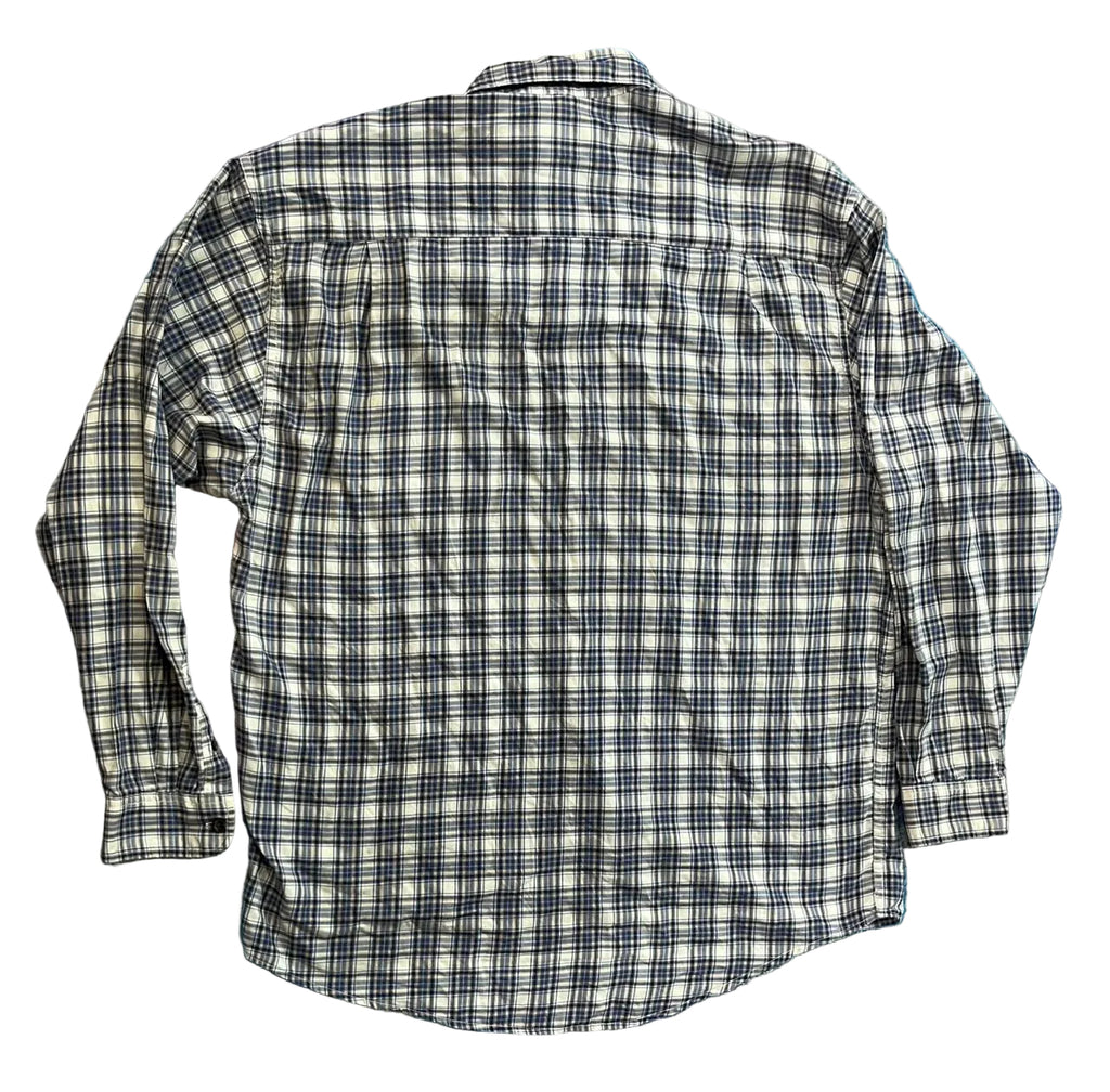 A long-sleeve plaid button-up shirt The shirt features a black, white, and gray plaid pattern.