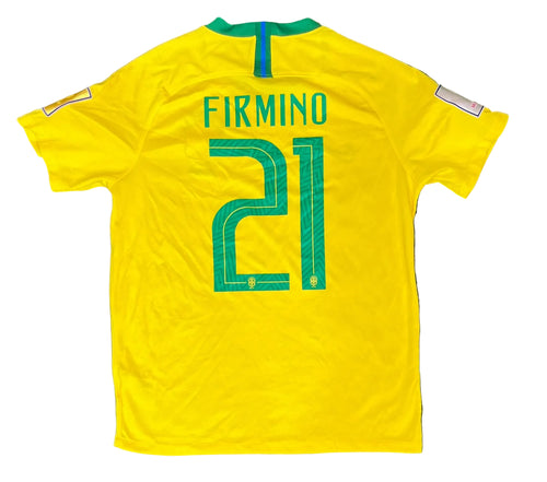 A yellow Brazil soccer jersey with 'FIRMINO' and the number '21' printed in green on the back