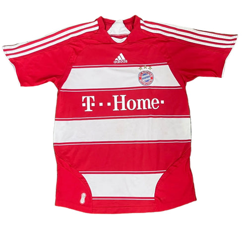 A red and white striped Adidas Bayern Munich soccer jersey with 'T-Home' sponsor branding