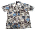 A short-sleeve button-up camp shirt with a tropical and Polynesian-inspired pattern,. The shirt features a beige base with black, white, and blue motifs including palm leaves, geometric patterns, and stars.