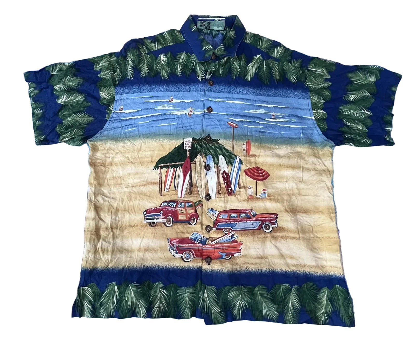 A short-sleeve button-up Hawaiian shirt The shirt features a tropical beach scene print with green palm leaves, a sandy beige beach, blue sky, surfboards, umbrellas, and red classic cars.