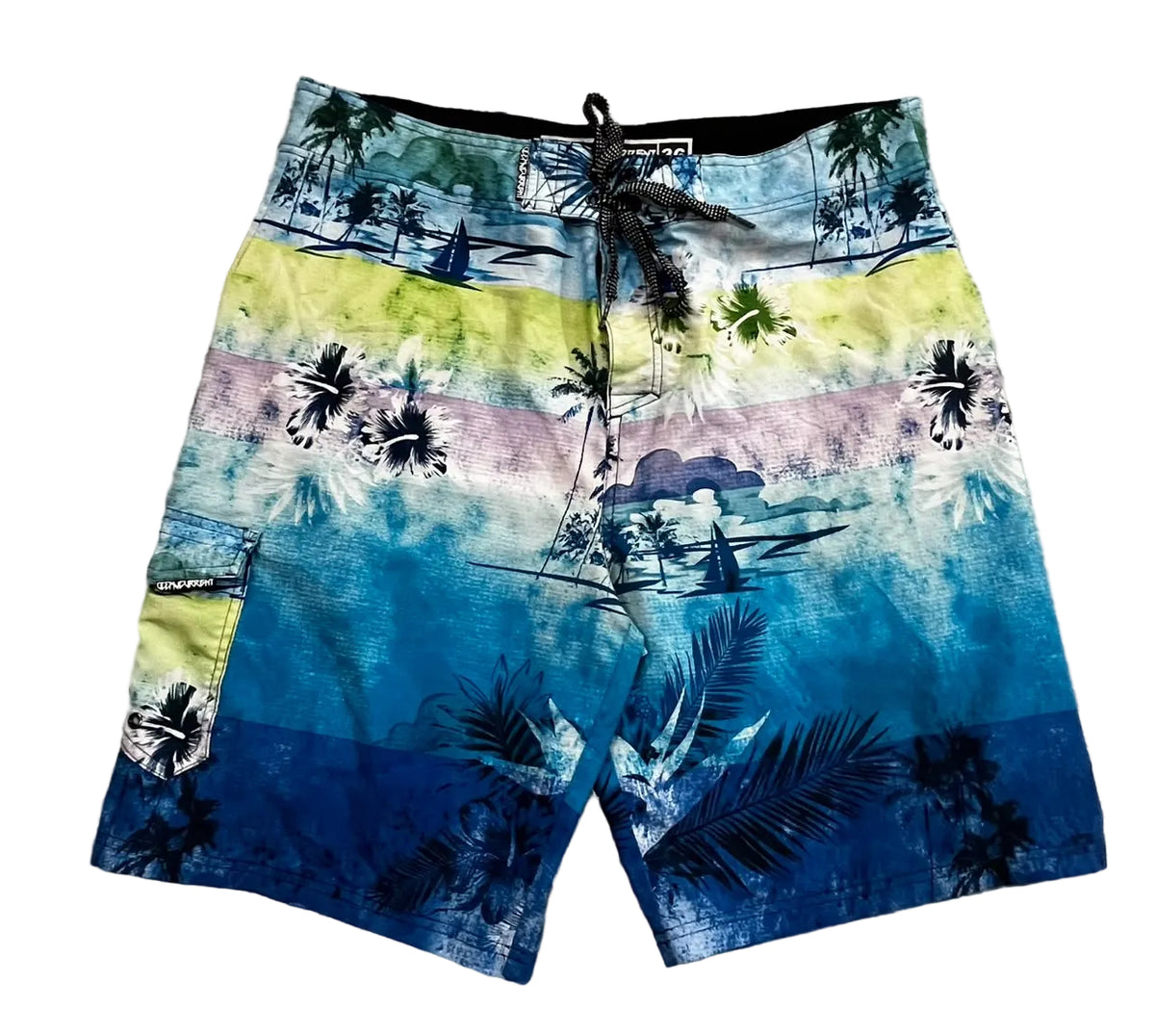 A pair of men's board shorts with a tropical beach print,. The print features blue, yellow, and pink watercolor stripes with black palm tree silhouettes and sailboats.