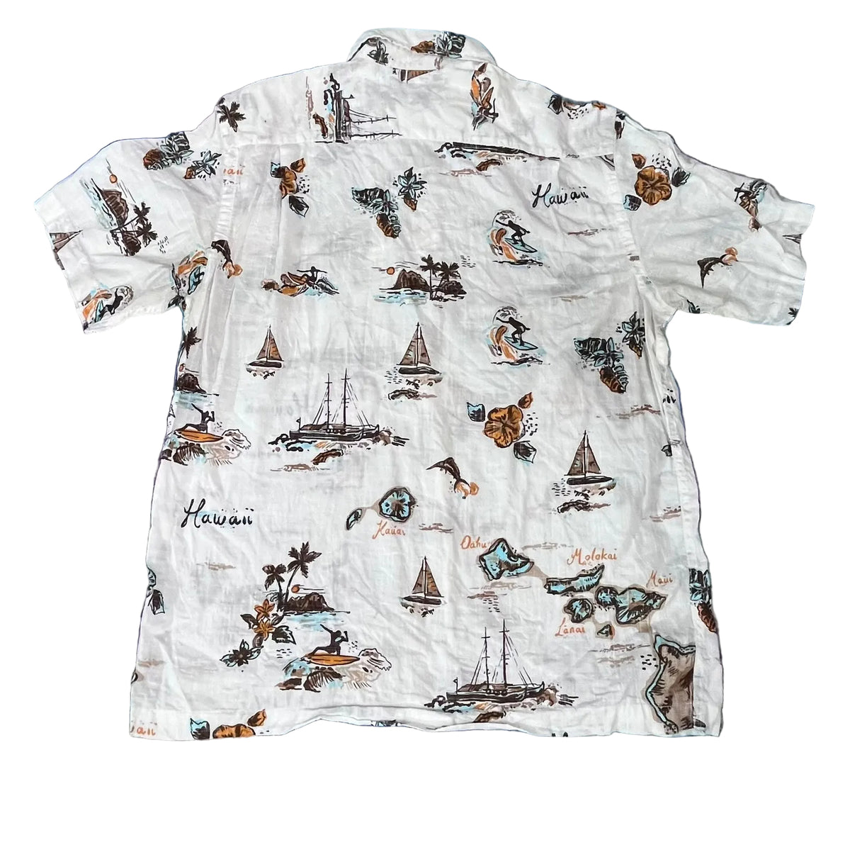 A white short-sleeve button-up shirt with a colorful Hawaiian-themed print featuring sailboats, islands, palm trees, and the word 'Hawaii' in script, 