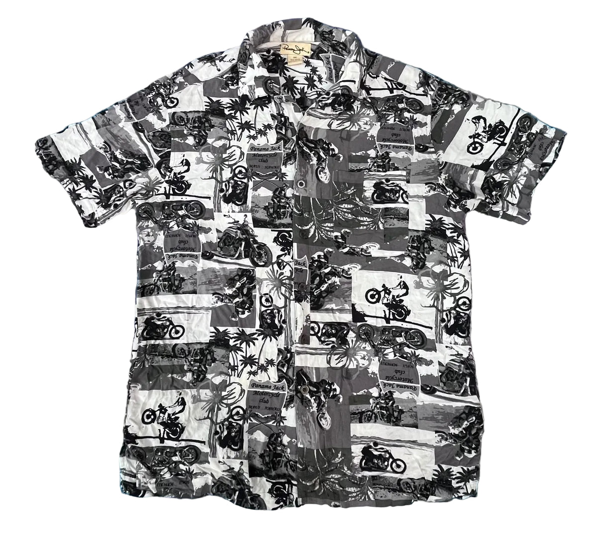A short-sleeve button-up camp shirt with a black and white patchwork print featuring motorcycles, palm trees, and beach scenes, 