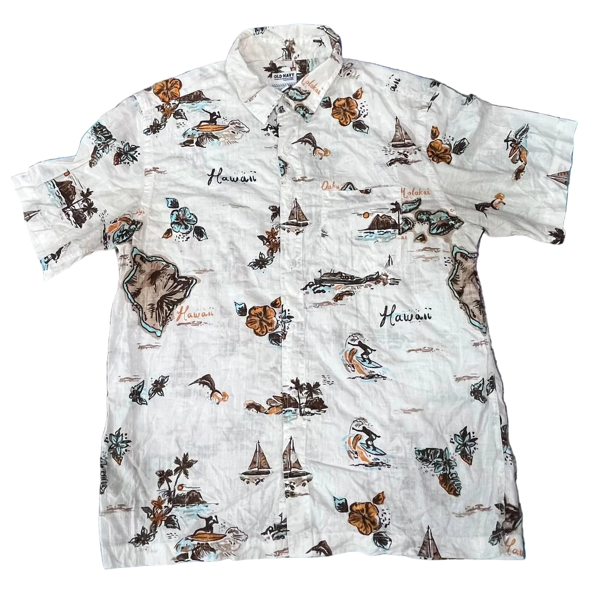 A white short-sleeve button-up Hawaiian shirt with a colorful tropical print featuring hula dancers, sailboats, palm trees, and the word 'Hawaii'